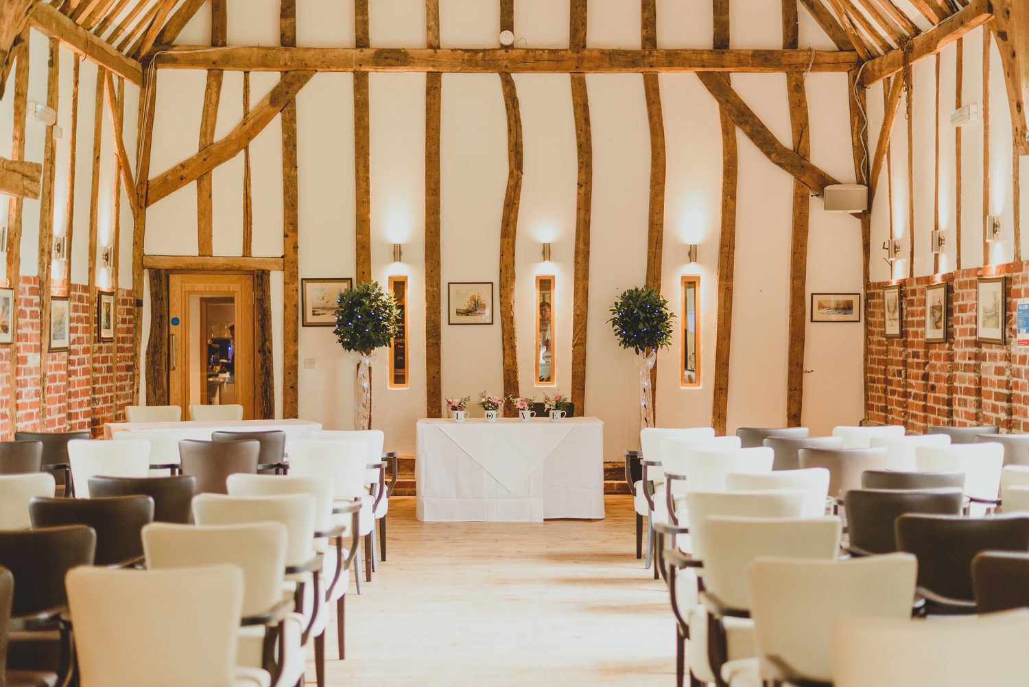Inside the oak beamed Crooked Barn set for a ceremony