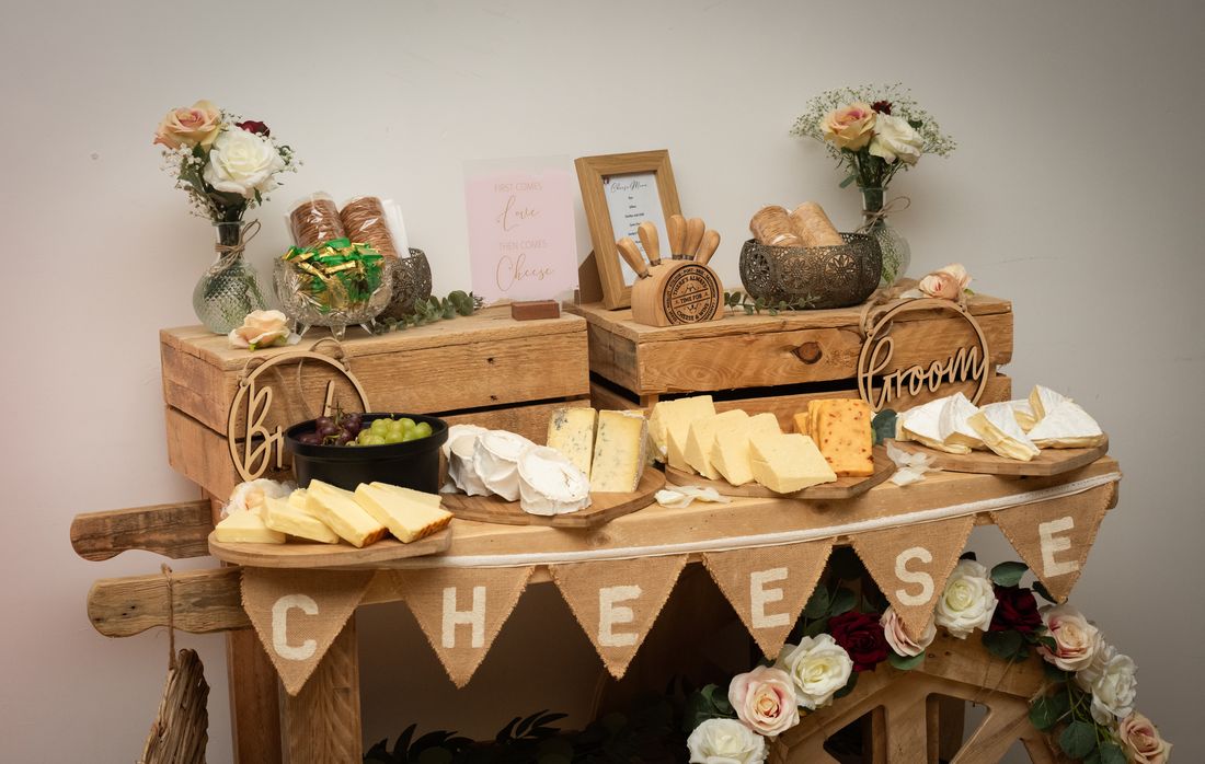 A rustic cheese table dressed with flowers
